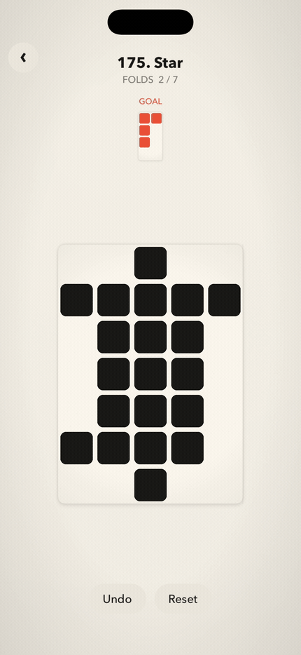 A coral and charcoal paper puzzle lifts and folds under a drag gesture.